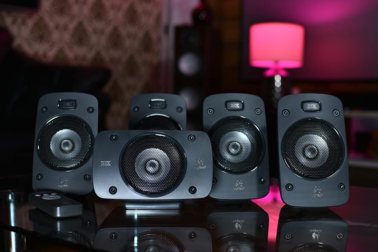 A close-up of a surround sound speaker system with remote, perfect for modern home entertainment.