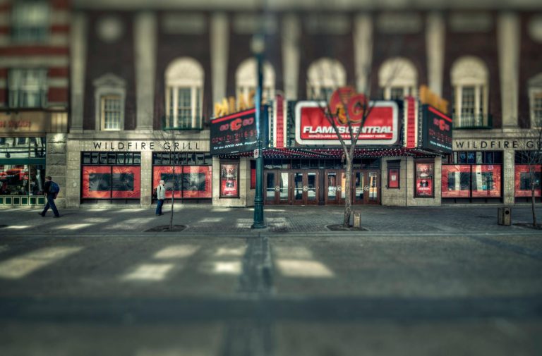 A quiet street view of a historical theater and surrounding urban architecture.